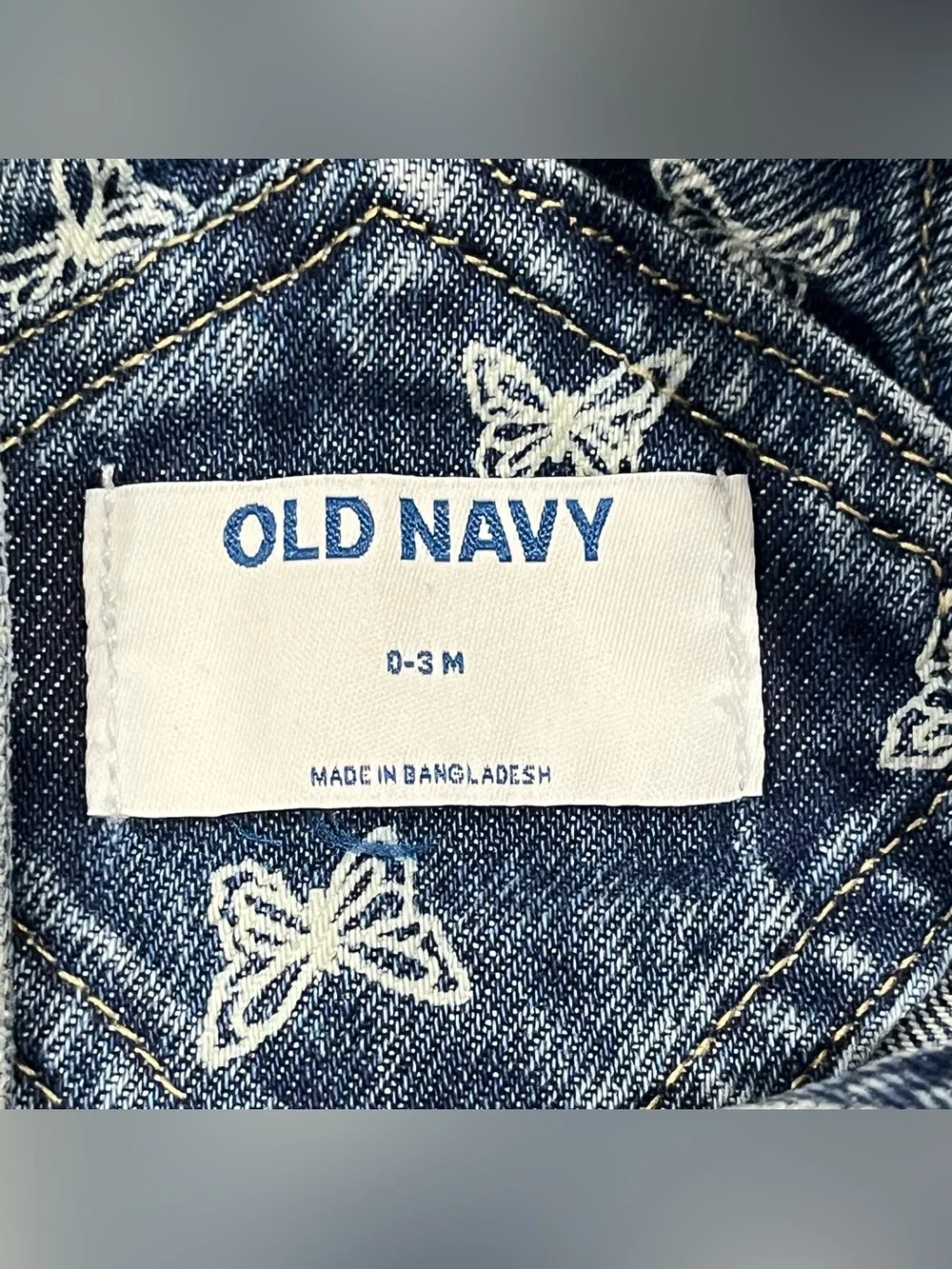 Old Navy jean romper for babies features an all-over white butterfly print 0-3